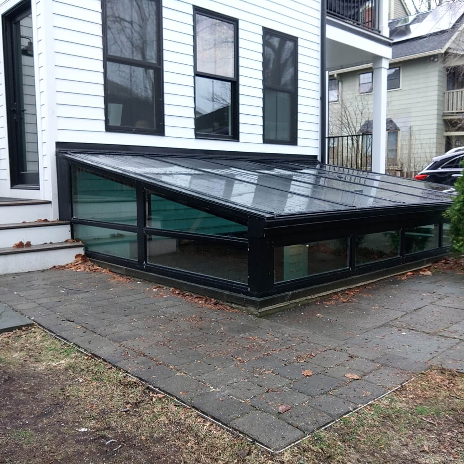 A in-ground patio room allows light into the lower floors.